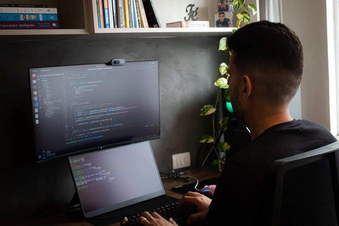 a man working on some code on his laptop